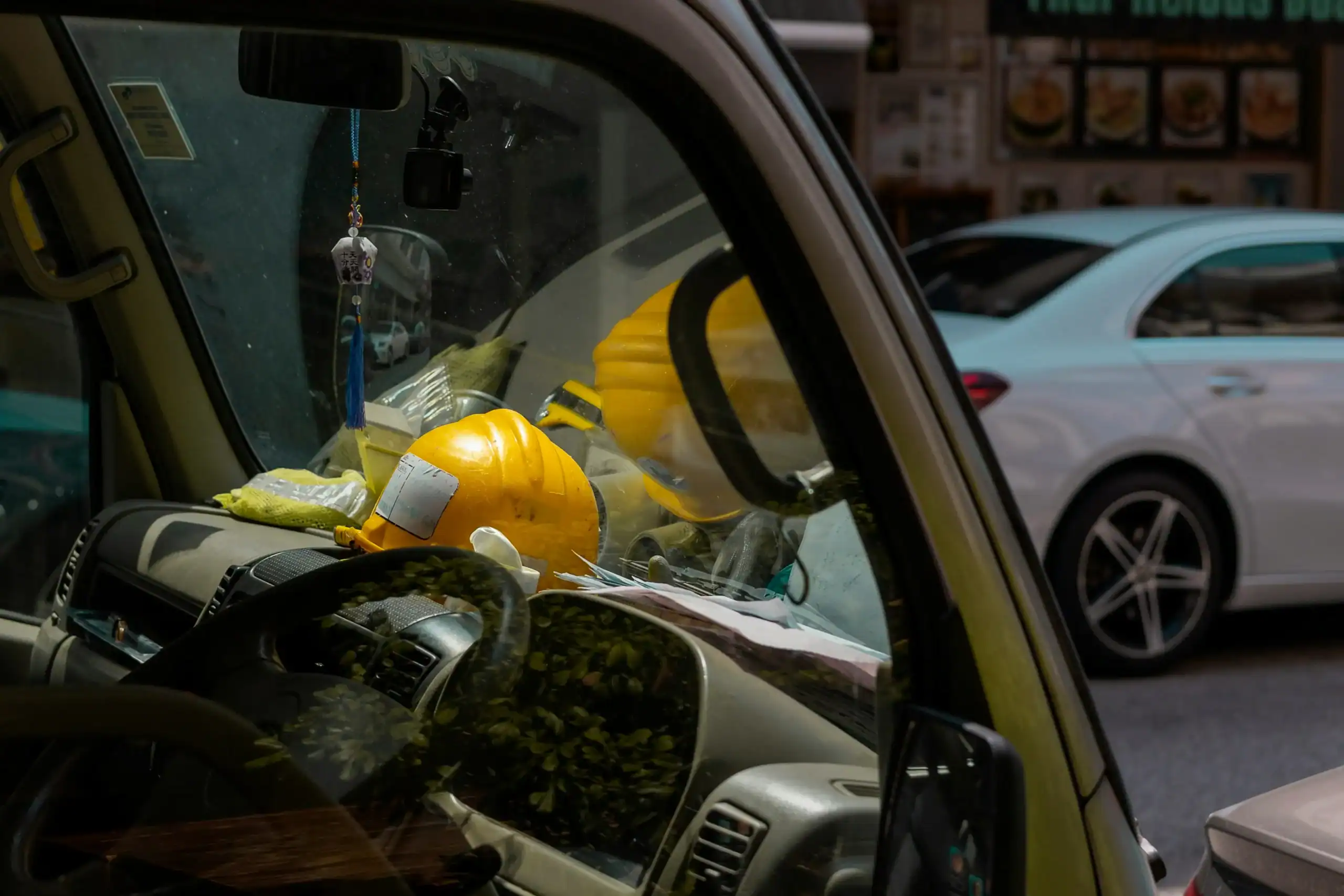 Car dashboard decoration with yellow plush toys and accessories.