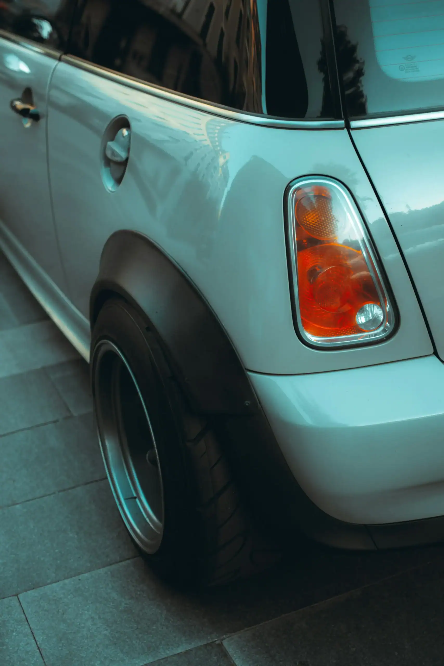 Mini Cooper rear side view with car accessory, close-up of vehicle details.