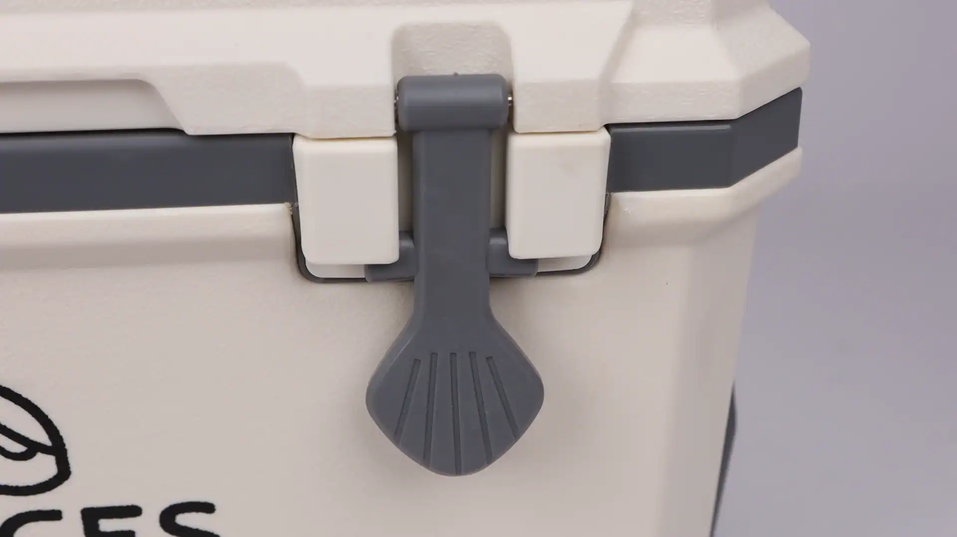 Close-up of a cooler latch mechanism featuring a durable gray and white design, showcasing high-quality materials.