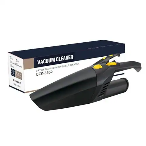 Compact black portable car vacuum cleaner with ergonomic handle and yellow accents alongside its branded packaging.