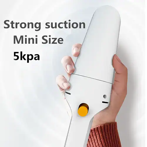 Compact white portable vacuum cleaner with 5kPa suction power shown held in hand, showcasing its strong suction and small size.